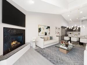 living room with lofted ceiling and light hardwood / wood-style floors