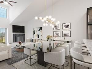 dining area featuring high vaulted ceiling, hardwood / wood-style flooring, and ceiling fan with notable chandelier