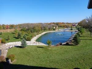 view of pool with a lawn