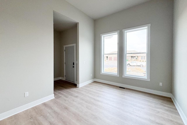 spare room with light hardwood / wood-style flooring