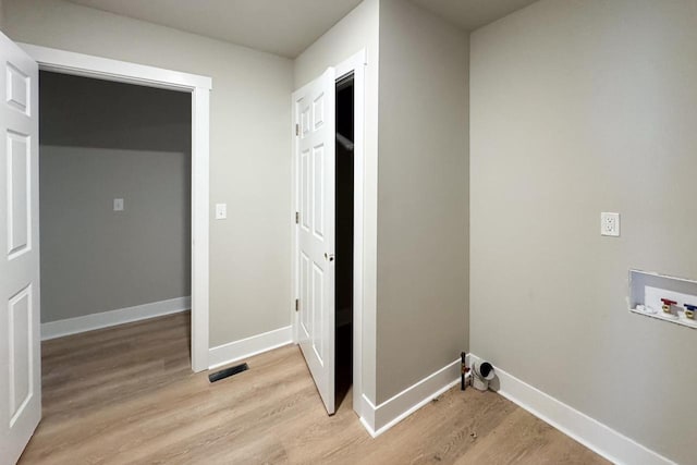 laundry area featuring light wood-type flooring and washer hookup