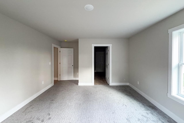 unfurnished bedroom with dark colored carpet