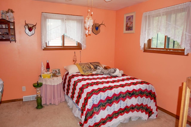 bedroom featuring light carpet