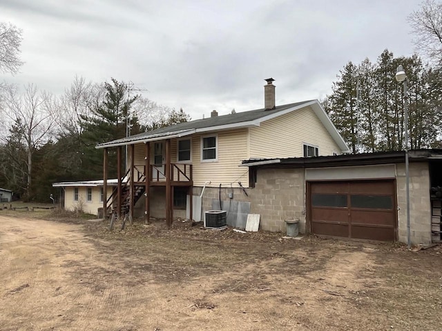 view of front of property featuring central AC and a garage