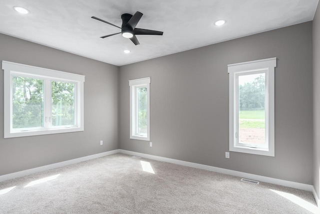 spare room with carpet flooring and ceiling fan