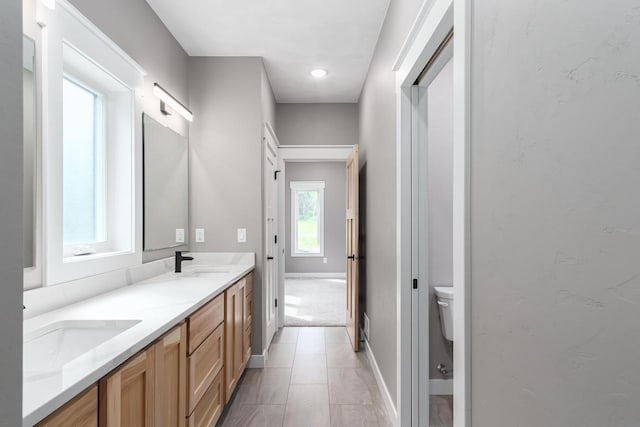 bathroom with tile patterned floors, vanity, and toilet