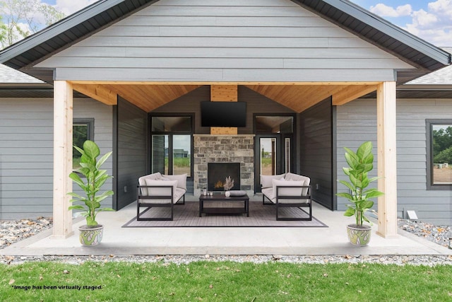 view of patio / terrace with an outdoor living space with a fireplace