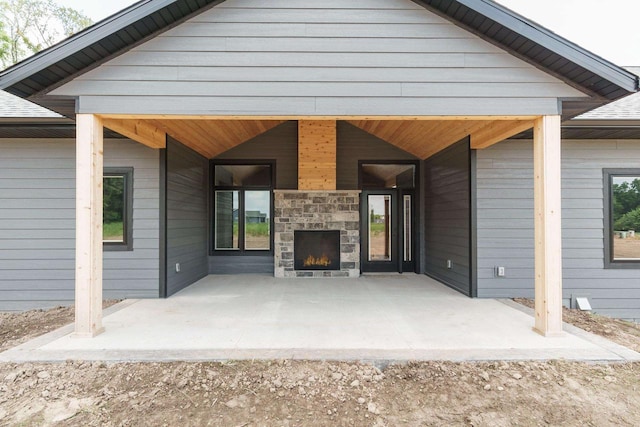 view of patio / terrace featuring an outdoor stone fireplace