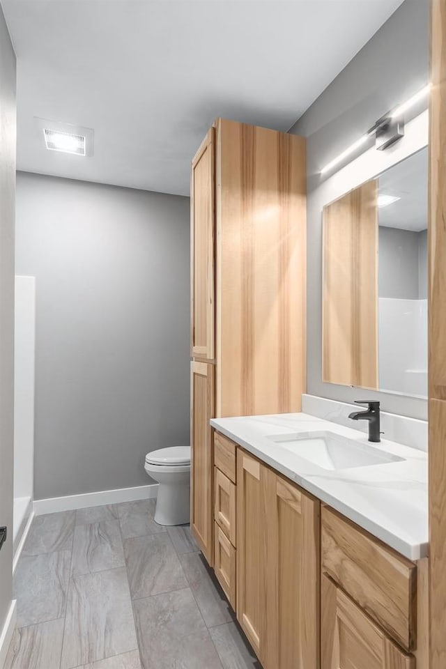 bathroom featuring vanity and toilet