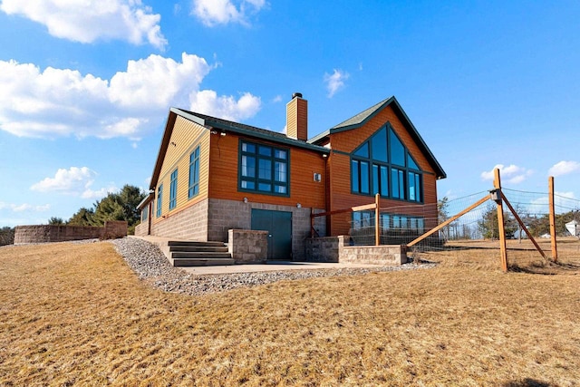 rear view of house featuring a lawn