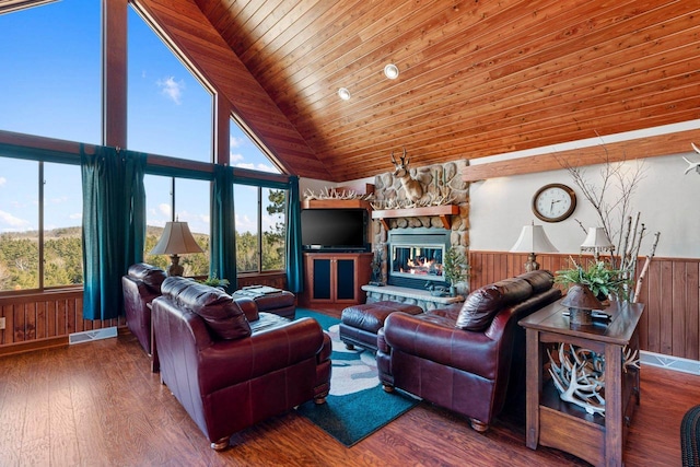 living room with high vaulted ceiling, dark hardwood / wood-style floors, wood ceiling, and a stone fireplace