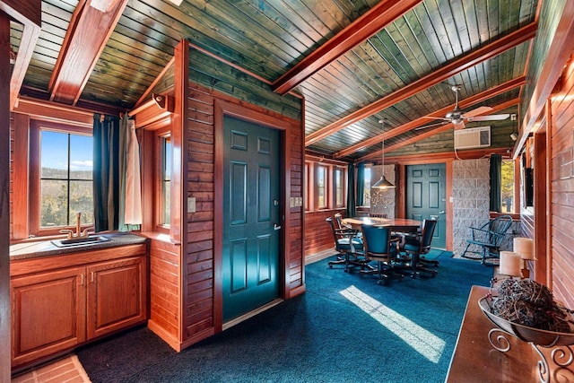 interior space featuring vaulted ceiling with beams, ceiling fan, sink, wood ceiling, and a wall mounted AC