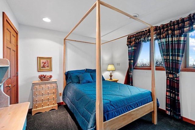 bedroom with dark colored carpet