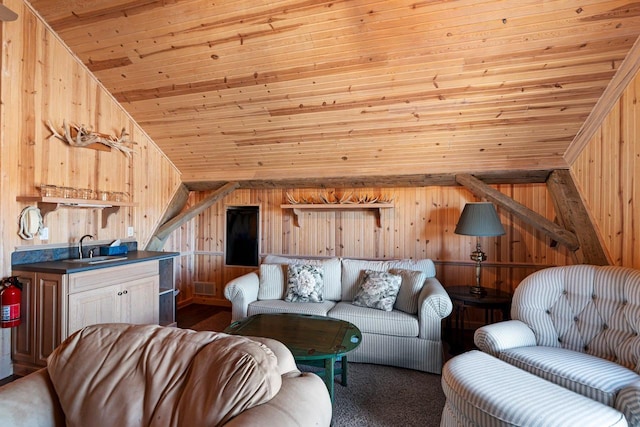 living room featuring sink, lofted ceiling, wood walls, and wooden ceiling