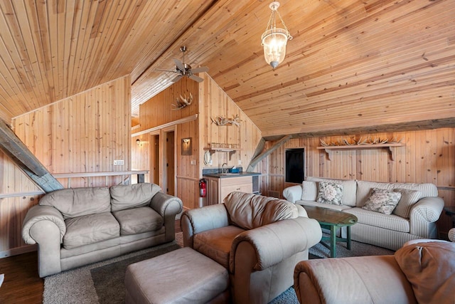 living room with wood ceiling, ceiling fan, wood walls, and dark wood-type flooring