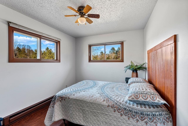 bedroom featuring ceiling fan, multiple windows, and a textured ceiling