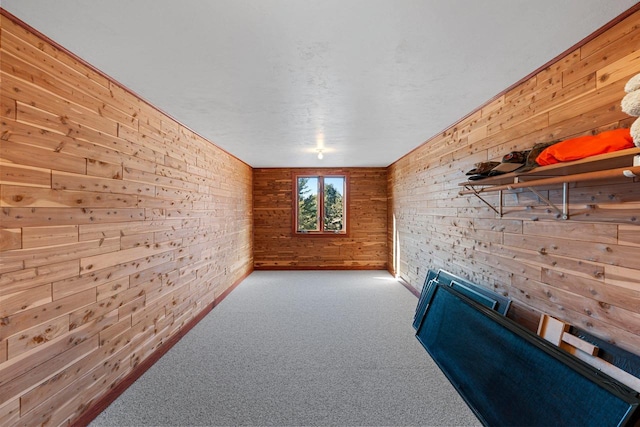 hall featuring light colored carpet and wood walls