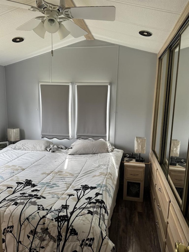 bedroom featuring ceiling fan, lofted ceiling, and dark wood-type flooring