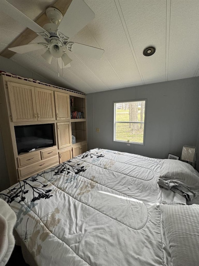 bedroom featuring ceiling fan and lofted ceiling