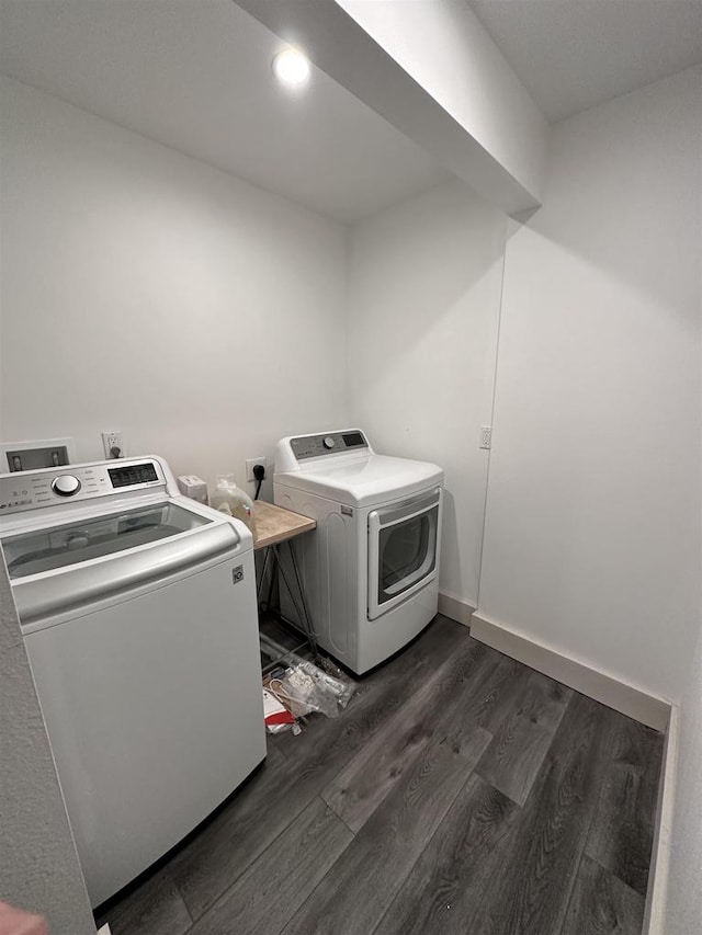 washroom featuring hookup for an electric dryer, dark wood-type flooring, and washer and dryer