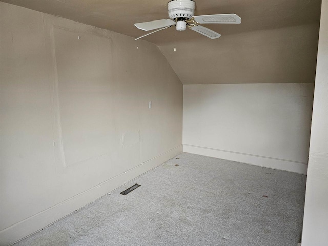 carpeted empty room with ceiling fan and lofted ceiling