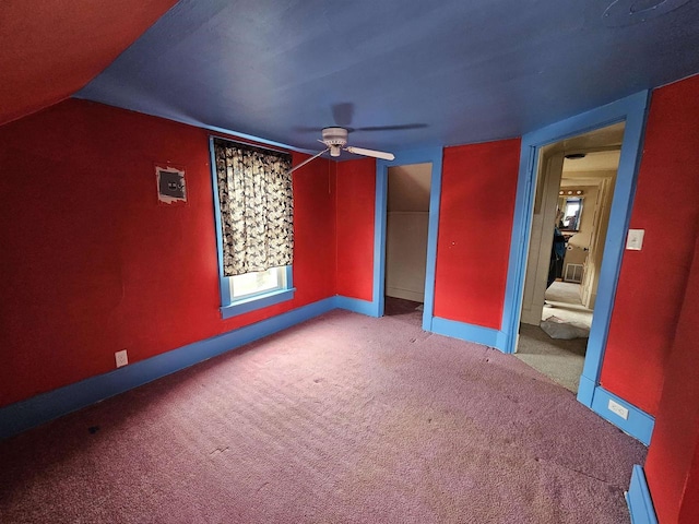 interior space featuring carpet flooring, ceiling fan, vaulted ceiling, and a baseboard heating unit