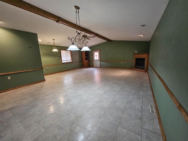 unfurnished living room featuring lofted ceiling with beams