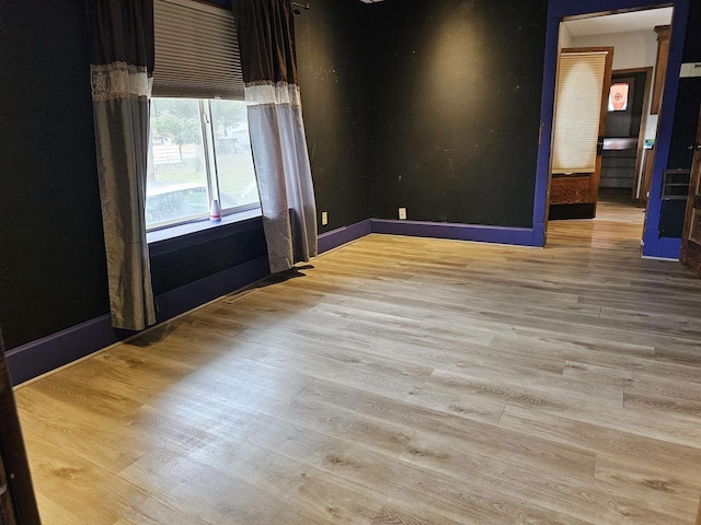 spare room featuring light hardwood / wood-style flooring