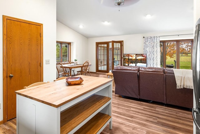 kitchen with wooden counters, lofted ceiling, a wealth of natural light, and light wood-type flooring