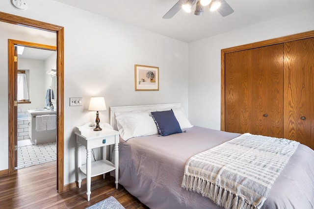 bedroom featuring dark hardwood / wood-style flooring, ceiling fan, and connected bathroom