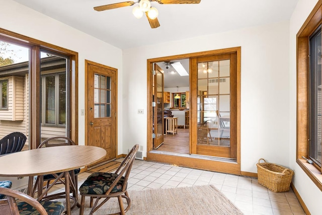 tiled dining area featuring ceiling fan