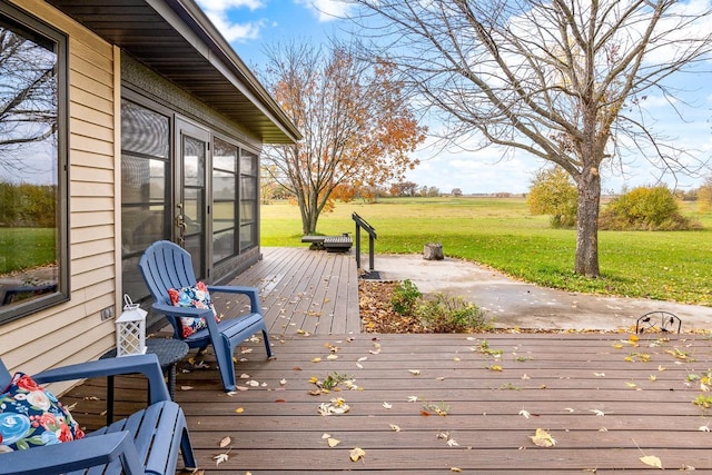 wooden deck featuring a lawn