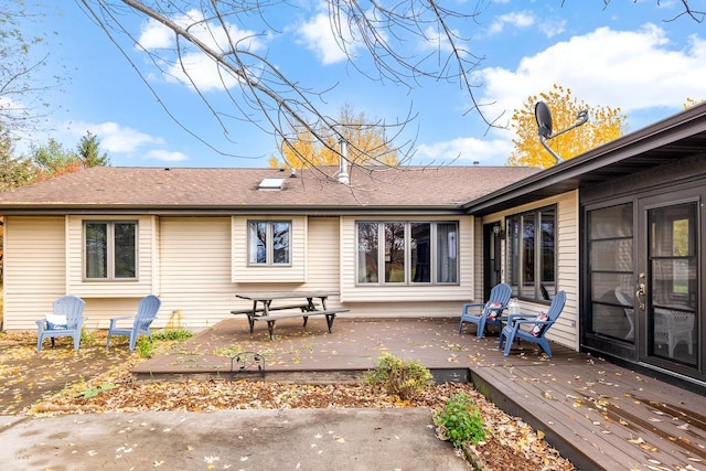 rear view of property with a wooden deck