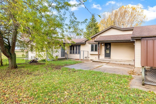 rear view of house with a patio and a yard