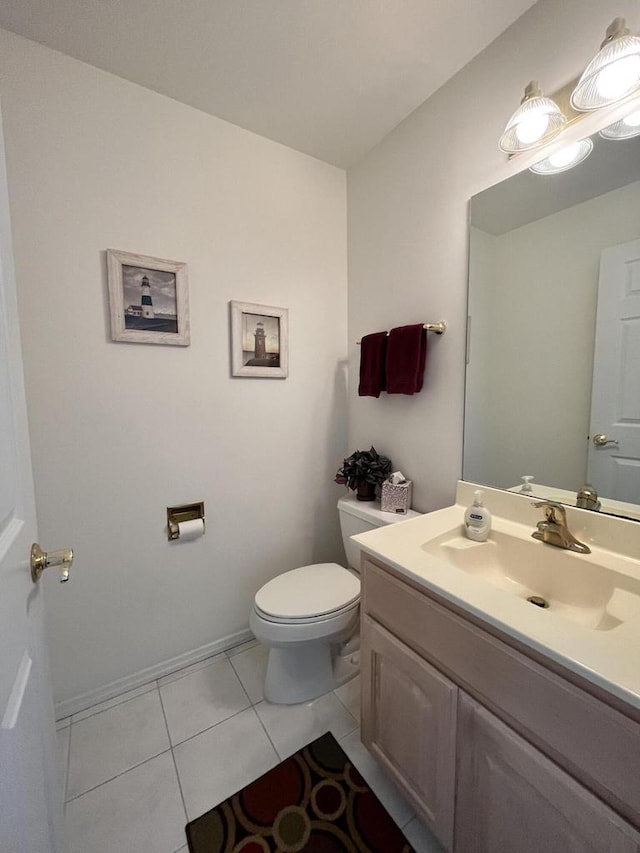 bathroom featuring vanity, tile flooring, and toilet