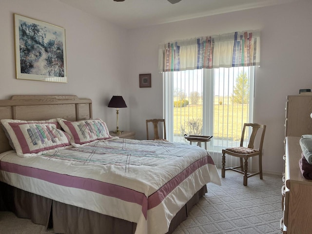 bedroom featuring ceiling fan and light carpet