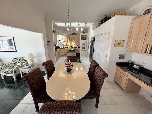 dining room featuring a chandelier and light tile floors