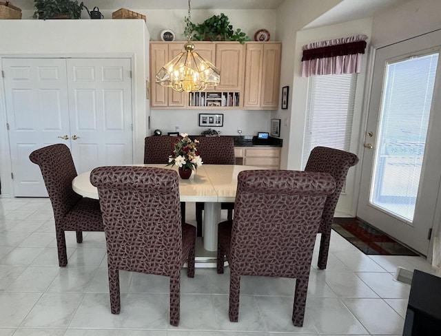 dining space featuring a chandelier and light tile floors