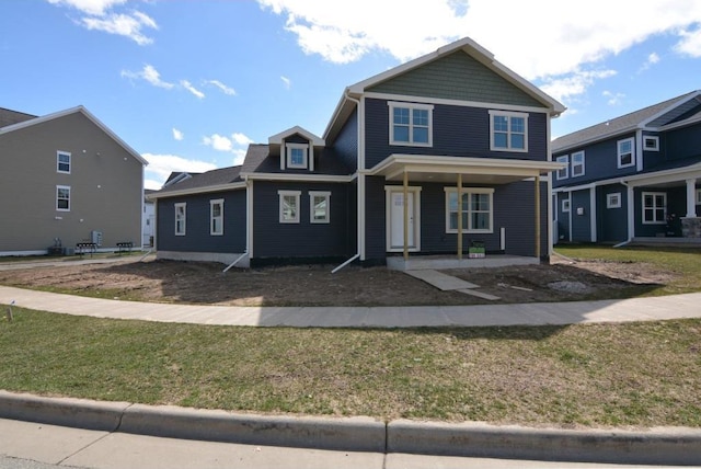 view of front of house featuring a porch and a front lawn