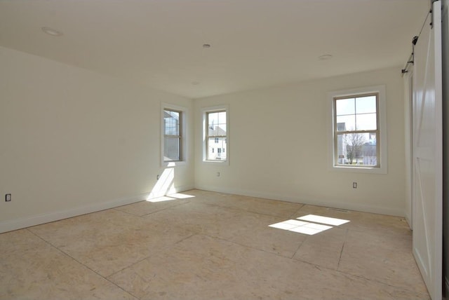 unfurnished room featuring plenty of natural light