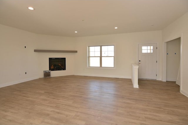 unfurnished living room with light wood-type flooring