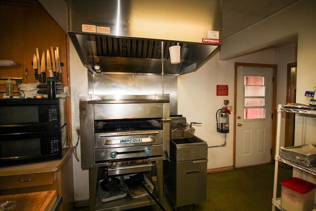 kitchen featuring stainless steel counters and black microwave