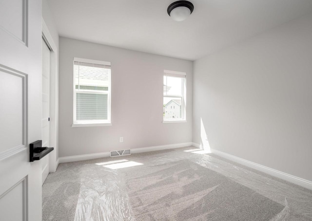 carpeted empty room with a healthy amount of sunlight