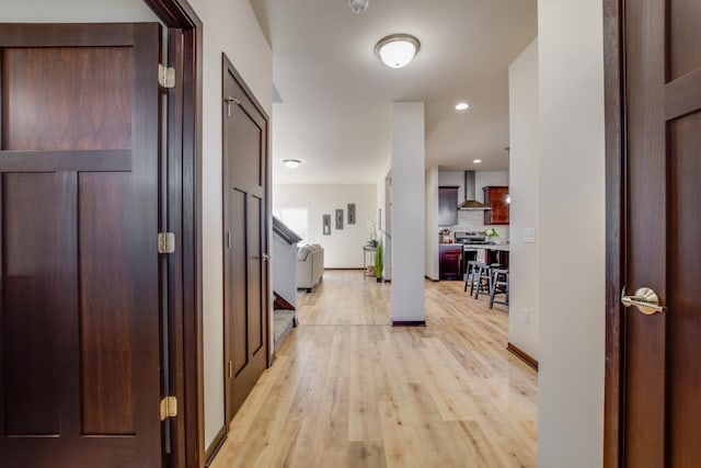 hallway with light hardwood / wood-style floors