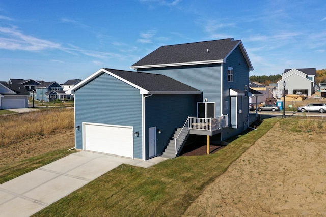 view of side of home with a yard and a garage