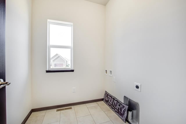 washroom with hookup for a washing machine, light tile patterned floors, and electric dryer hookup