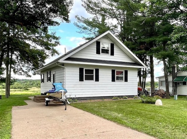 back of property featuring a lawn