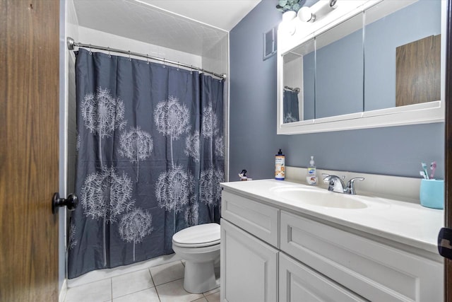 bathroom featuring large vanity, tile floors, and toilet