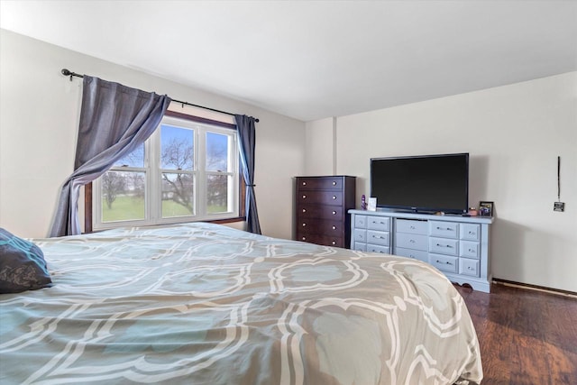 bedroom with dark wood-type flooring