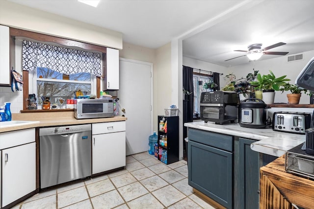 kitchen with ceiling fan, stainless steel appliances, light tile floors, sink, and white cabinets